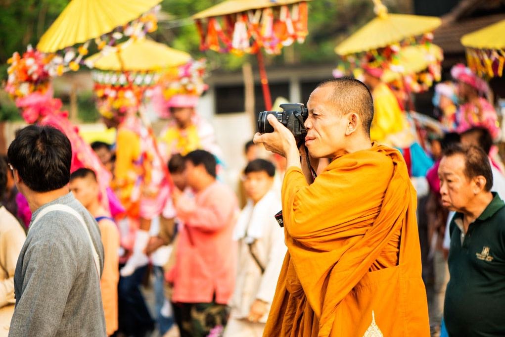 Monk taking street photos