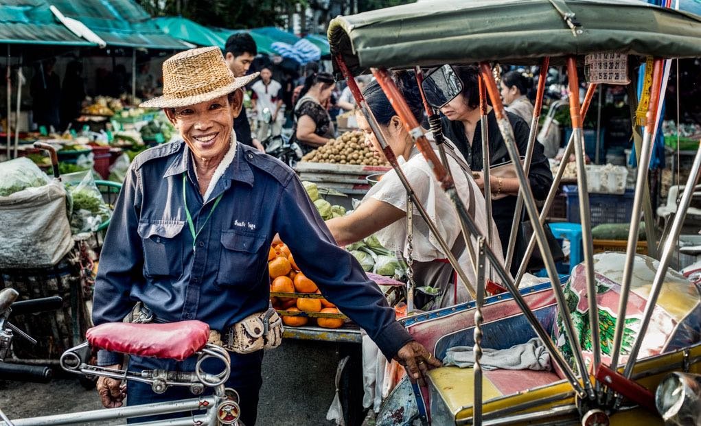 Warorot Market in the day with a samlor rider