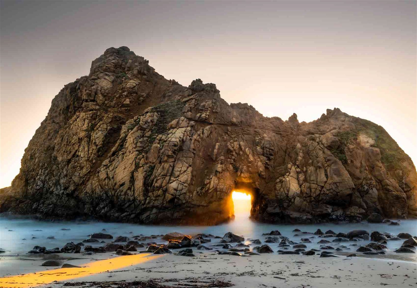 sunrise framed inside a rock.