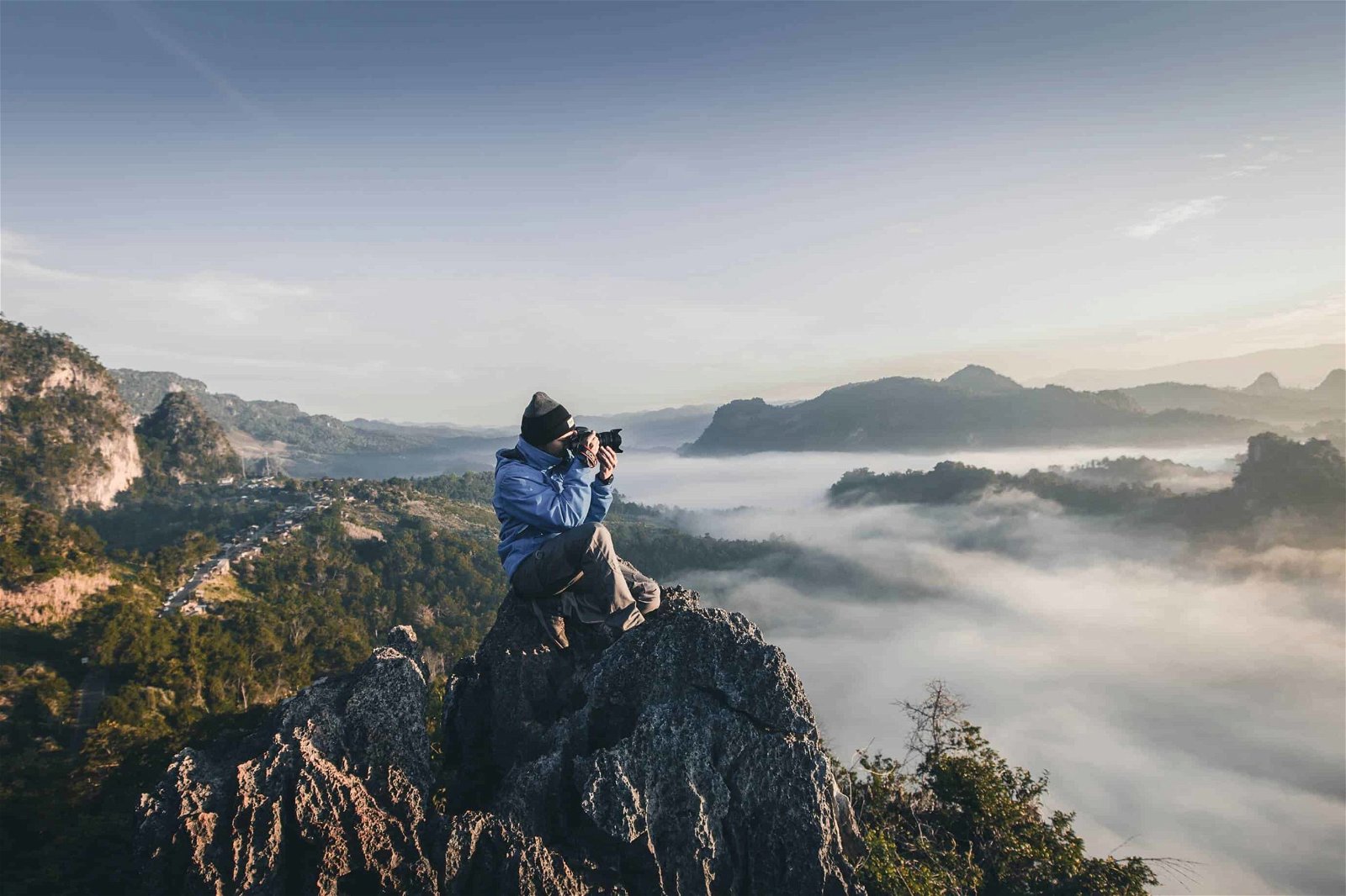 Wear appropriate clothing for the weather and the picture. It's a great travel photography tip and is demonstrated by the clothing worn by this photographer on a mountaintop.