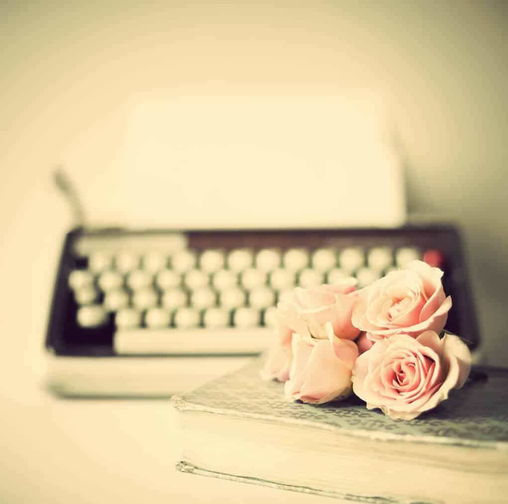 bouquet of flowers lying in front of a typewriter.