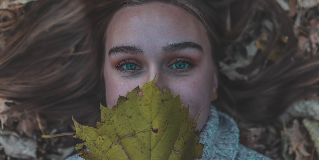 raw image of a women holding a leaf.