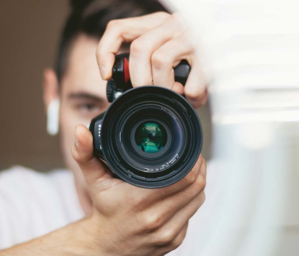 person shooting with a DSLR camera.