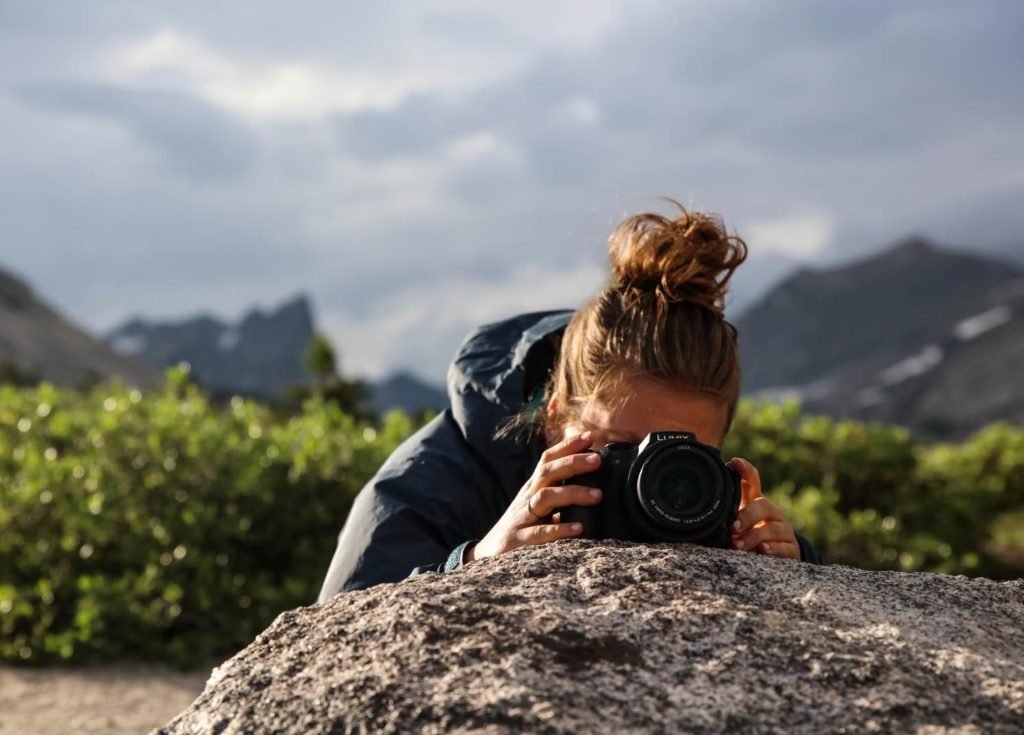 photographer taking nature photos outdoors.