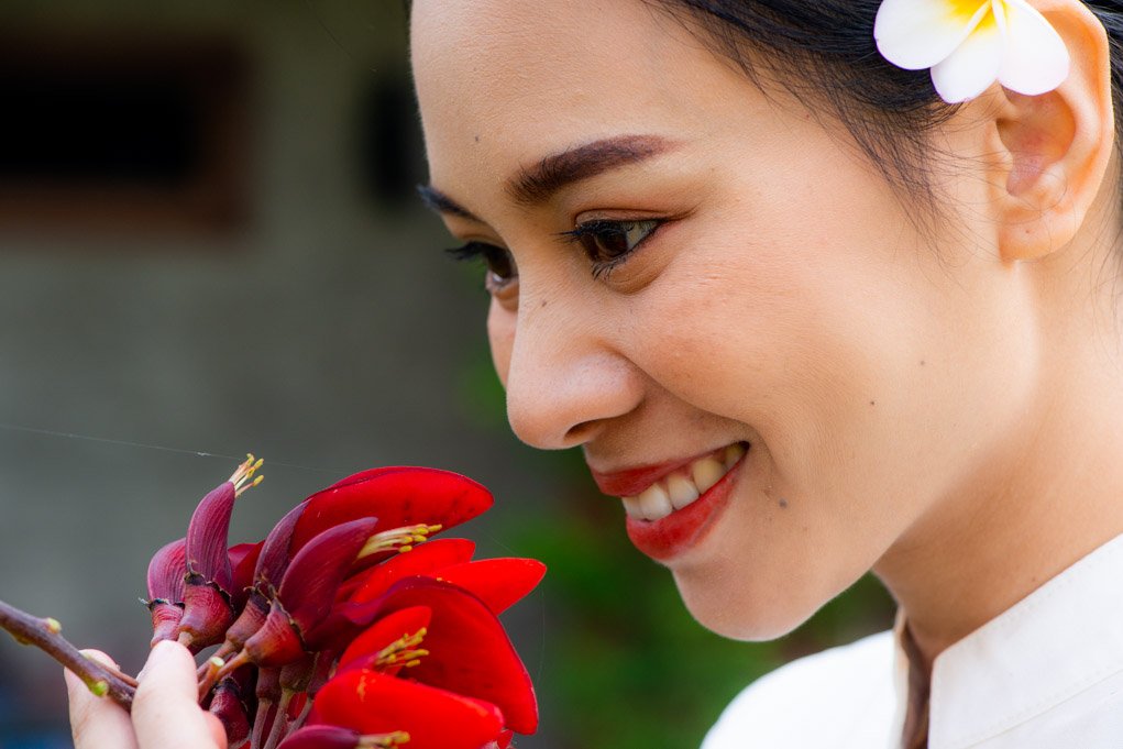 women with a red color flower.
