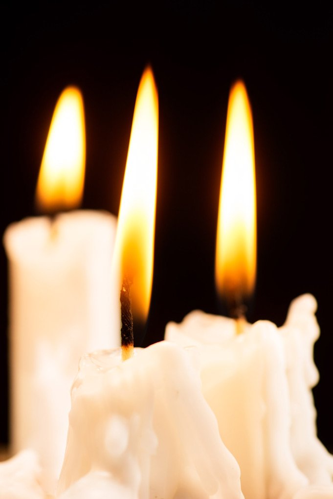 candles burning with a dark color background.