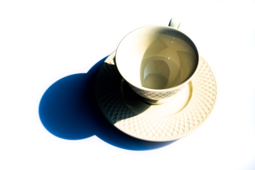 high contrast photograph of a white cup.