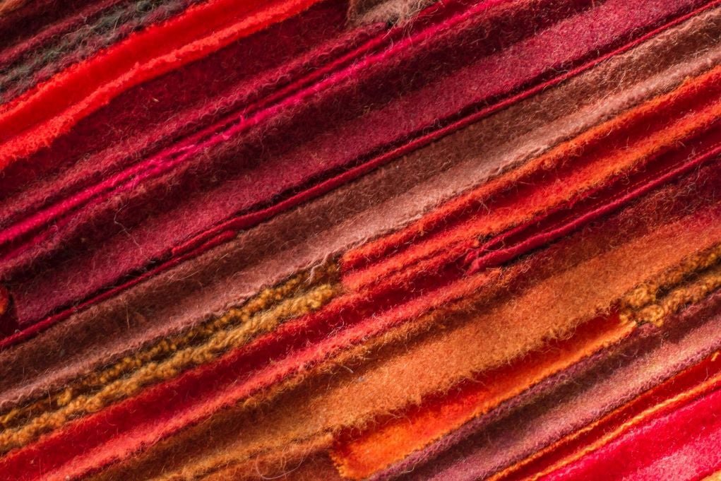 unique macro photo of red felted wool textures.